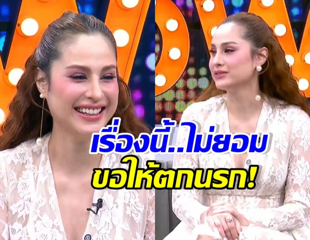 Two women in lace outfits sit on a TV talk-show set, smiling, with a large blue-and-yellow Thai caption across the screen.