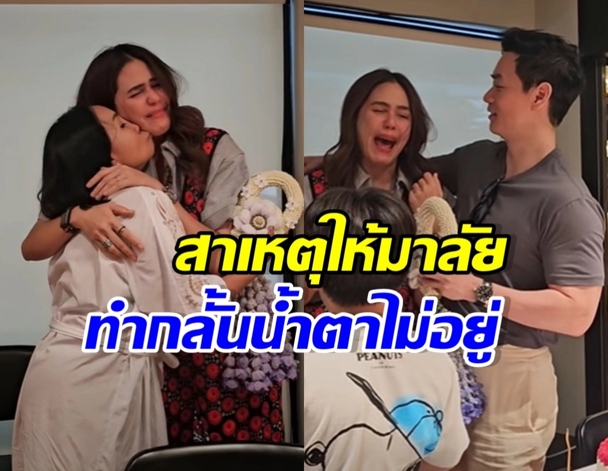 Two women embrace and cry in an indoor setting while a man watches, with others nearby and bouquets visible.