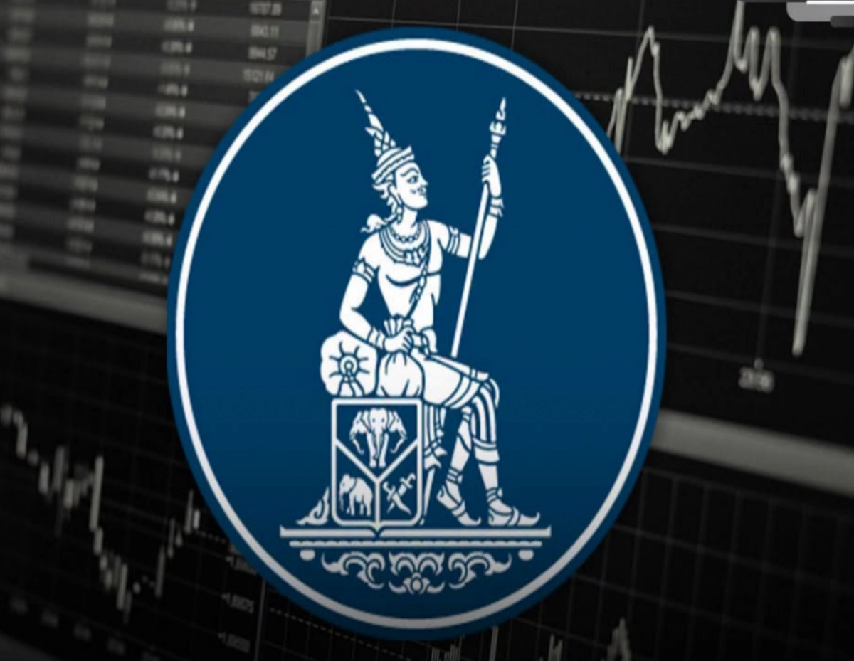 Blue circular emblem showing a seated figure holding a staff atop a shield, overlaid on a dark stock market chart background.