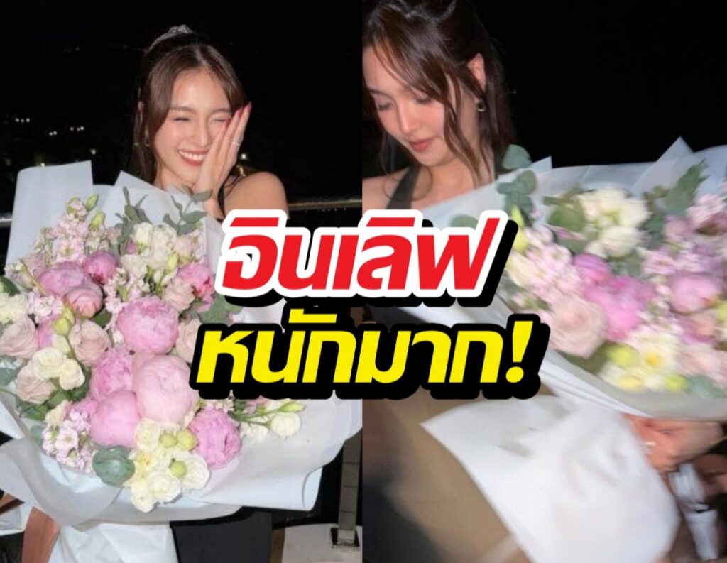 Two women at night hold oversized pink and white bouquets, smiling, with bold Thai caption overlay across the center.