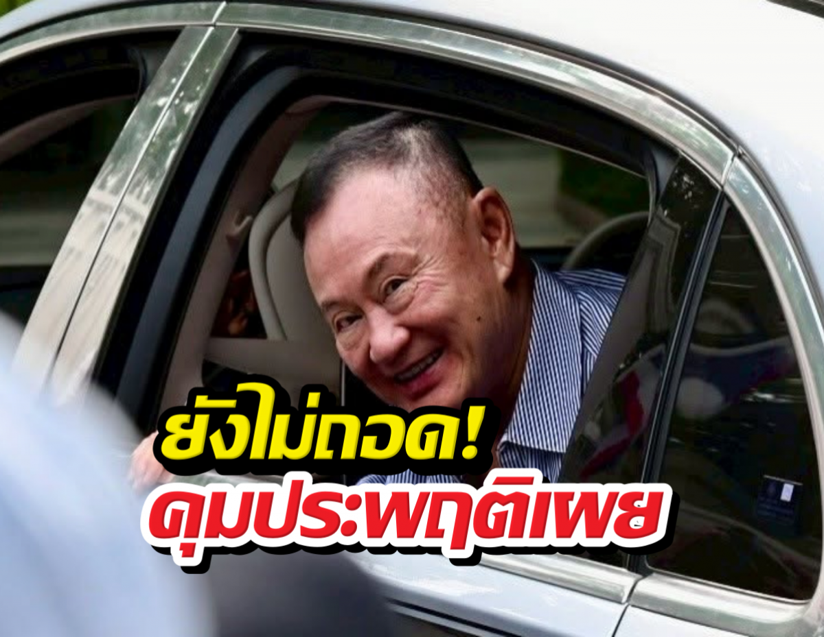 Man smiling from inside a car, with large yellow and red Thai caption overlaying the image.